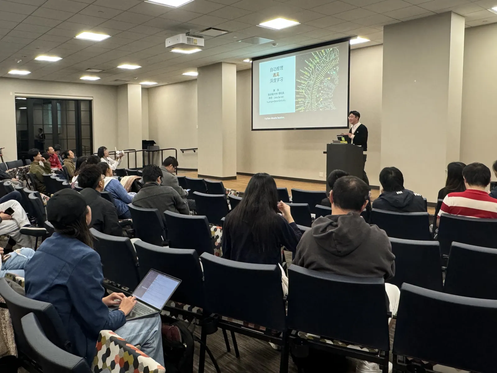 A speaker presenting autonomous driving and deep learning topics to the SCPA community