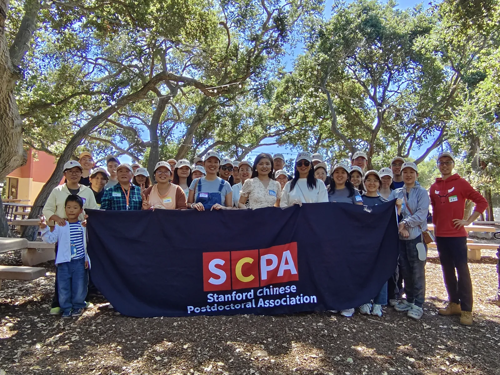 SCPA community members holding the association banner outdoors